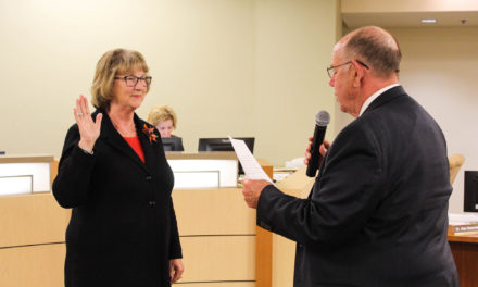 Two Board members take a familiar oath